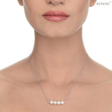 Load image into Gallery viewer, "Moonshine" features white pearls secured on a delicate sterling silver chain with rhodium plating. This simple statement piece works beautifully with collared shirt at work and low cut necklines.