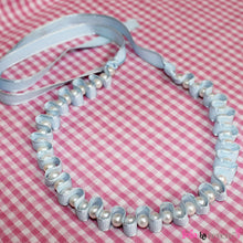 Load image into Gallery viewer, Delicate freshwater water pearls woven into satin ribbon for a royal yet dainty effect. This piece measures 12" around the neck and has 4" ribbon tie on each side.