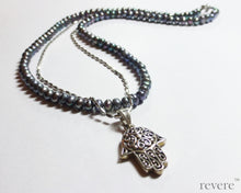 Load image into Gallery viewer, This elegant strand of dark grey pearls is beautifully complimented by a sparkling silver chain and hand shaped charm pendant. "Khamsa" represents blessings, power and strength and is believed to be a sign of protection against the evil eye.