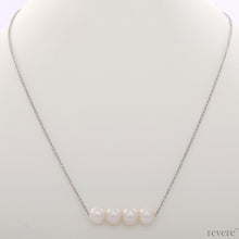 Load image into Gallery viewer, "Moonshine" features white pearls secured on a delicate sterling silver chain with rhodium plating. This simple statement piece works beautifully with collared shirt at work and low cut necklines.
