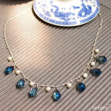 Load image into Gallery viewer, Effervescent blue crystal weaved together with freshwater white pearls as a beautiful statement necklace. "Verve" is sure to be the fun accessory in any gathering!