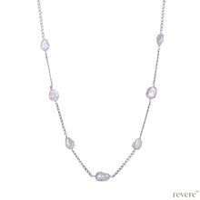 Load image into Gallery viewer, Gaia features gorgeous white freshwater keshi pearls scattered on a sterling silver chain (rhodium plated). Keshi pearls are irregular shaped pearls with character and sheen. This earthy design is subtle and can be styled with any casual look.
