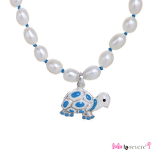 Load image into Gallery viewer, White freshwater pearls handknotted with blue thread with a blue and white tortoise pendant delicately suspended. Add some blue to any outfit.The necklace measures 14&quot; with an adjustable chain of 2&quot; to increase length to 16&quot;.
