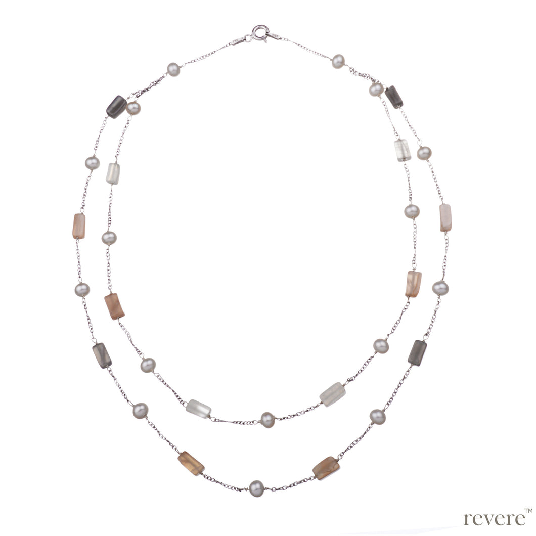 Jazzy necklace features sterling silver chain in double strand embellished with white freshwater pearl and multi-hued moonstones. Pair this with any outfit to look more sensuous.