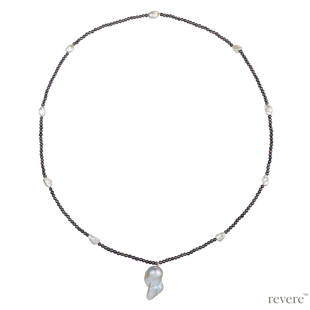 Create a standout look in this stunning necklace featuring white keshi pearl contrasted with freshwater black pearl, hand knotted and ending in a beautiful white baroque pearl pendant.