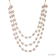 Load image into Gallery viewer, Covet features three strings of delicate white freshwater pearls beautifully threaded on gold cord and fastened by an silver clasp. Elegant, graceful and elaborate, sure to make you feel like a princess.
