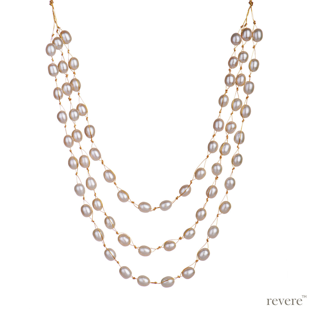 Covet features three strings of delicate white freshwater pearls beautifully threaded on gold cord and fastened by an silver clasp. Elegant, graceful and elaborate, sure to make you feel like a princess.