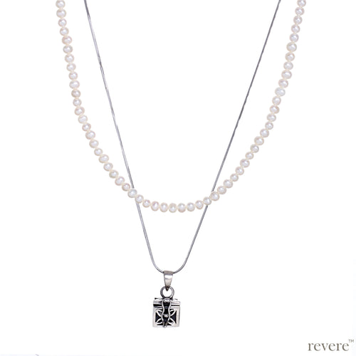 Dive into the magical temptation of this stunning Budhhist box pendant in attractive design made of sterling silver.The neckpiece features a 2 strand design, one strand of white pearls and a second of sterling silver chain and a beautiful Budhhist pendant in sterling silver.