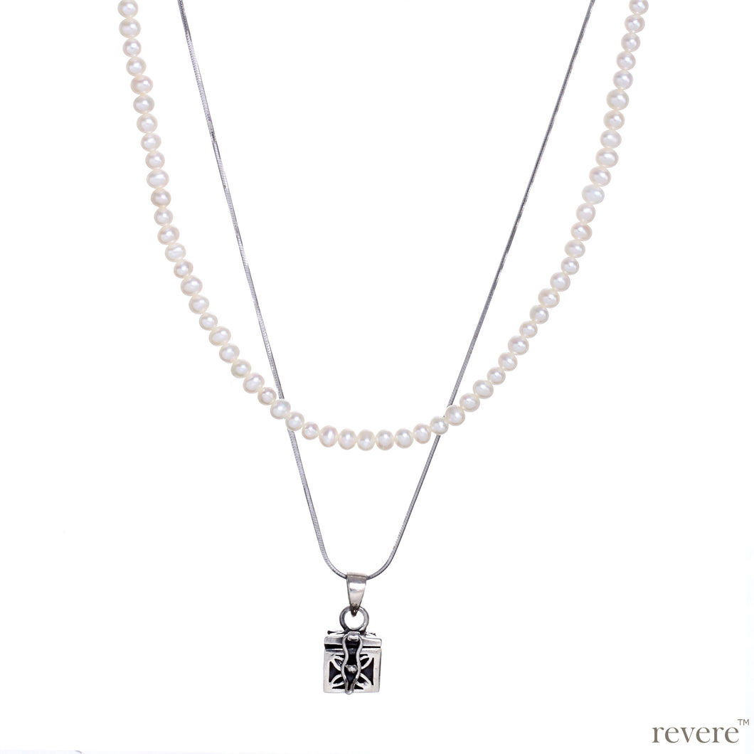 Dive into the magical temptation of this stunning Budhhist box pendant in attractive design made of sterling silver.The neckpiece features a 2 strand design, one strand of white pearls and a second of sterling silver chain and a beautiful Budhhist pendant in sterling silver.