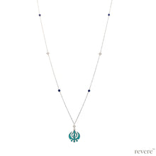 Load image into Gallery viewer, Victorious.. inspired by the symbolic integration of spiritual &amp; temporal authorities represented in the &quot;khanda&quot; through the edges of crossed swords, a double edged sword and a chakram. This piece features a recycled Turquoise&quot;khanda&quot; pendant set in sterling silver, embellished with real freshwater white pearls and lapis lazuli suspended on a long sterling silver chain with rhodium plating.
