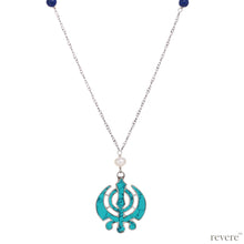 Load image into Gallery viewer, Victorious.. inspired by the symbolic integration of spiritual &amp; temporal authorities represented in the &quot;khanda&quot; through the edges of crossed swords, a double edged sword and a chakram. This piece features a recycled Turquoise&quot;khanda&quot; pendant set in sterling silver, embellished with real freshwater white pearls and lapis lazuli suspended on a long sterling silver chain with rhodium plating.
