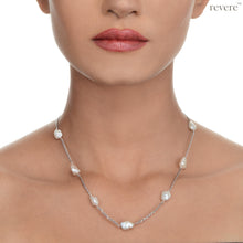 Load image into Gallery viewer, Gaia features gorgeous white freshwater keshi pearls scattered on a sterling silver chain (rhodium plated). Keshi pearls are irregular shaped pearls with character and sheen. This earthy design is subtle and can be styled with any casual look.
