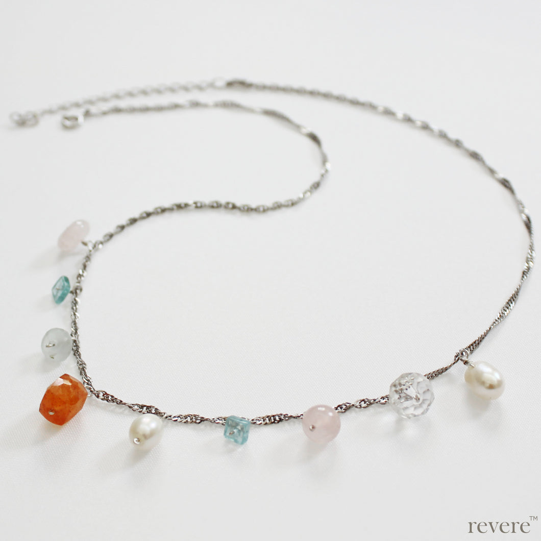 Felicity features drops of pearl, crystal, rose quartz, apatite, green aventurine, cornaline on sterling silver with an extendable chain, rhodium plated.