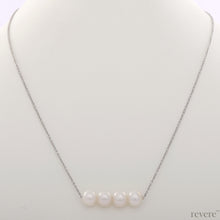 Load image into Gallery viewer, &quot;Moonshine&quot; features white pearls secured on a delicate sterling silver chain with rhodium plating. This simple statement piece works beautifully with collared shirt at work and low cut necklines.
