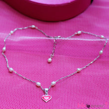 Load image into Gallery viewer, Sterling silver pink heart shaped pendant on a sterling silver chain scattered with baby pink pearls. Ideal for any little girl who loves pink.
